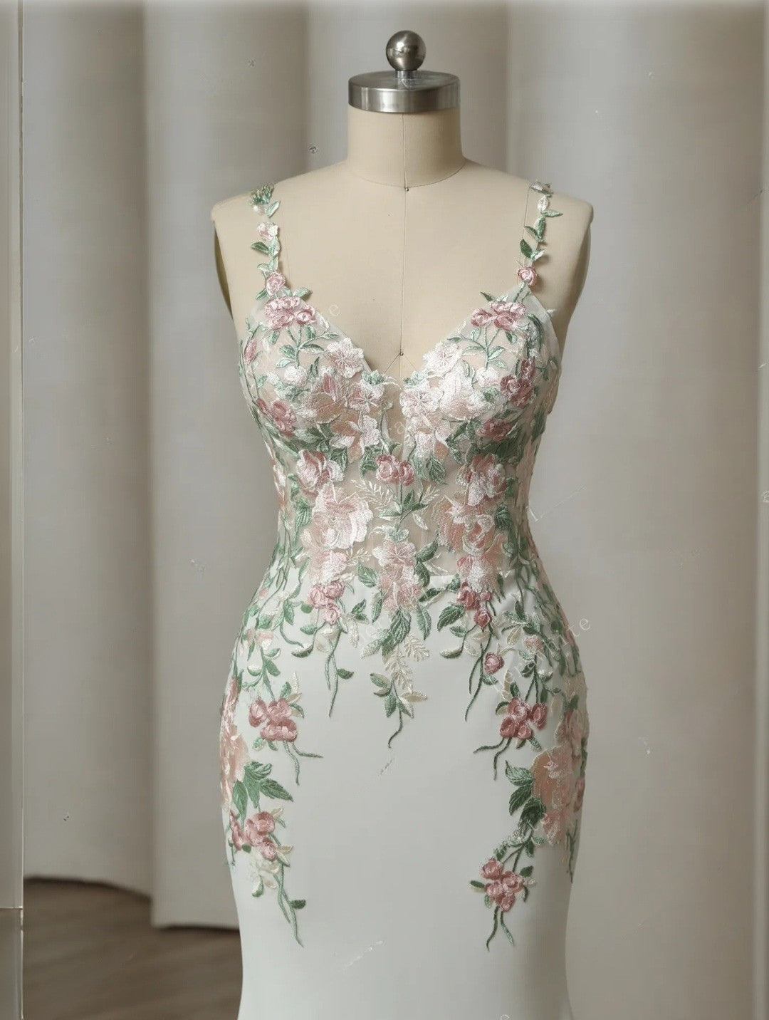 Floral dress on a mannequin against a plain background
