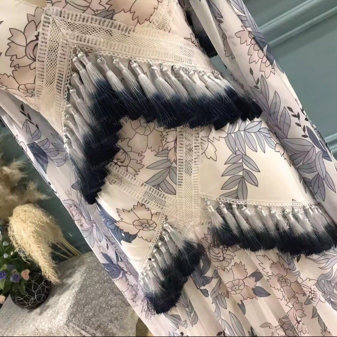 Floral-patterned fabric with black and white fringe on a textured surface