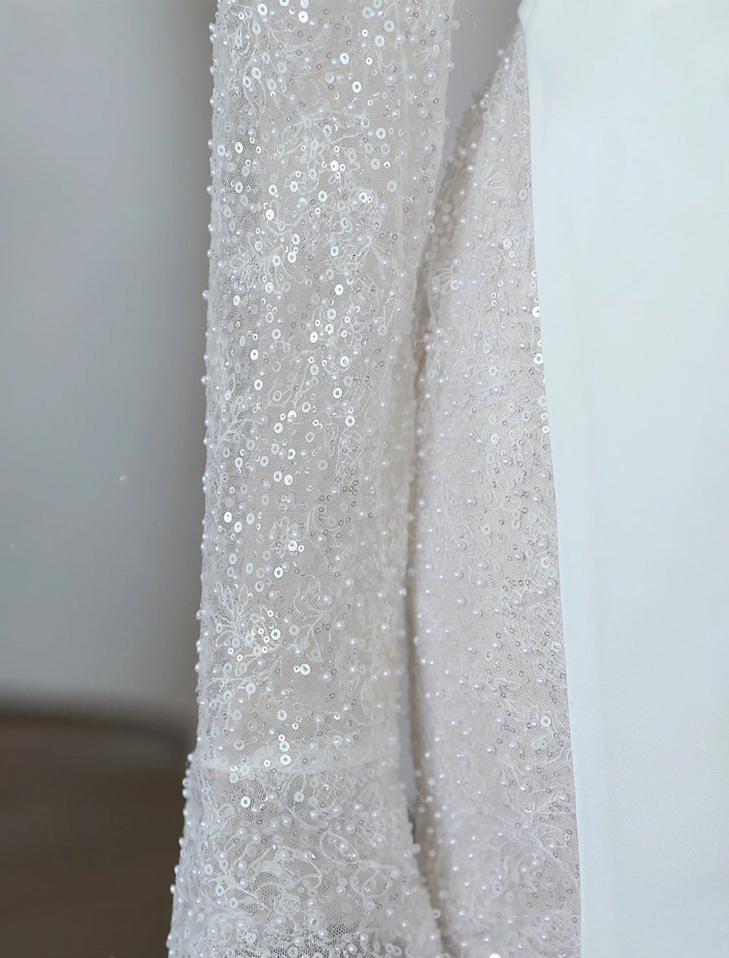 Close-up of a silver sequined fabric against a white background