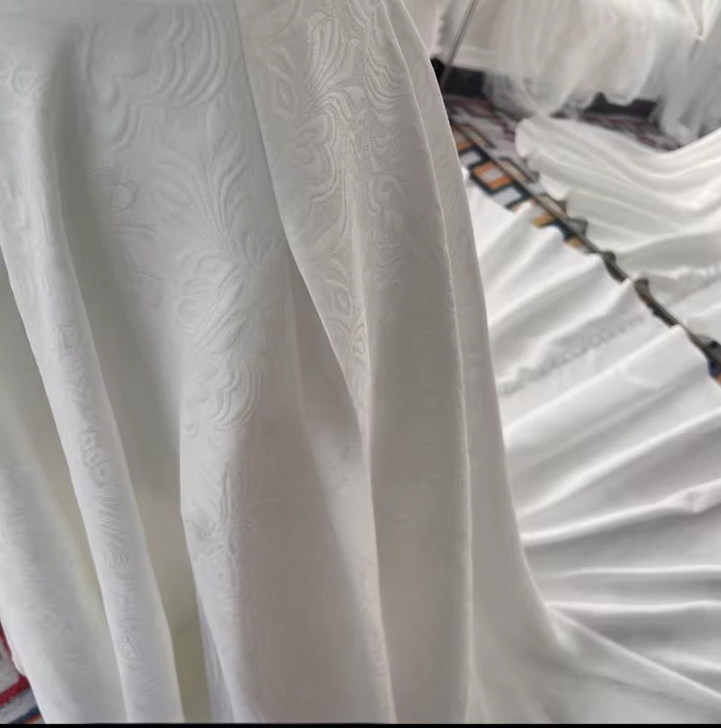 Close-up of white textured fabric with a blurred background