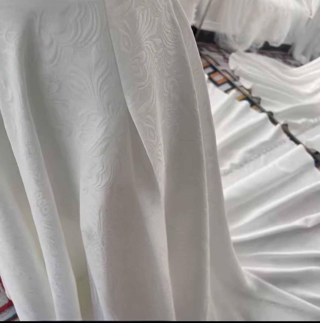 Close-up of white textured fabric with a blurred background