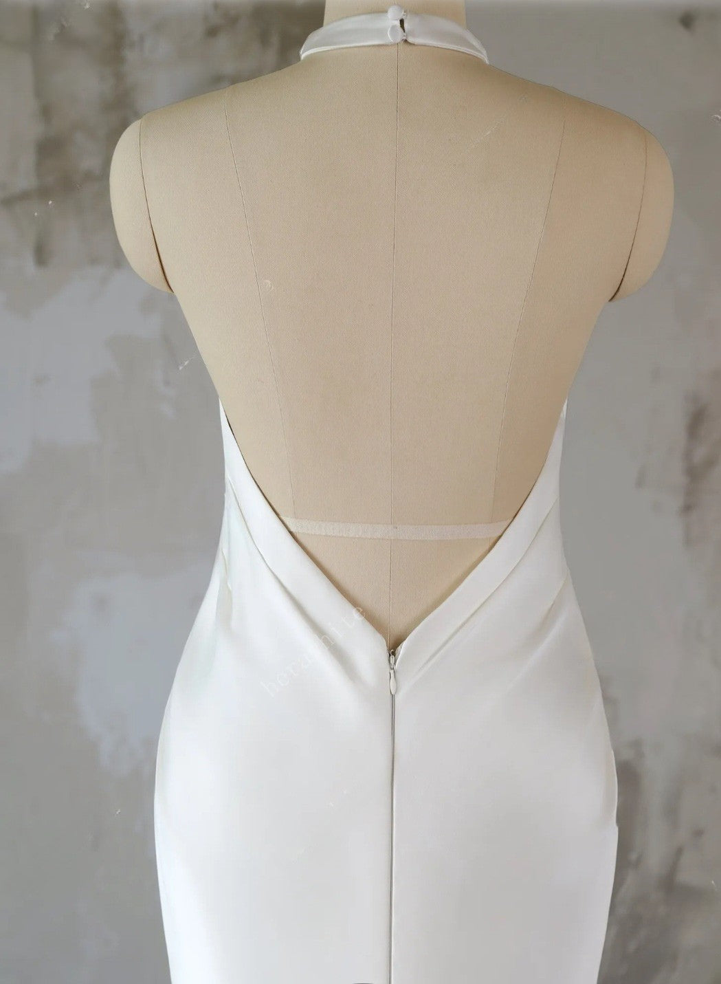 White dress on a mannequin with a plain background