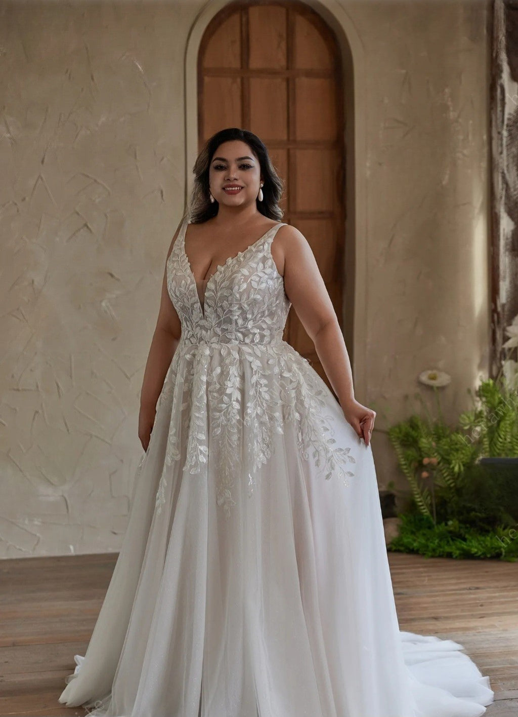 Woman in a white wedding dress standing in front of a rustic building.