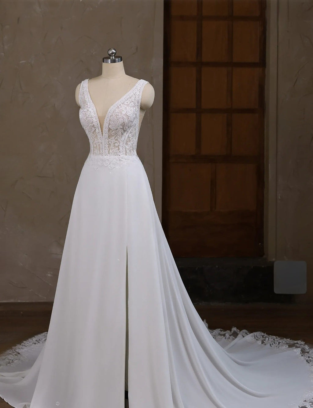 White wedding dress on a mannequin against a neutral background