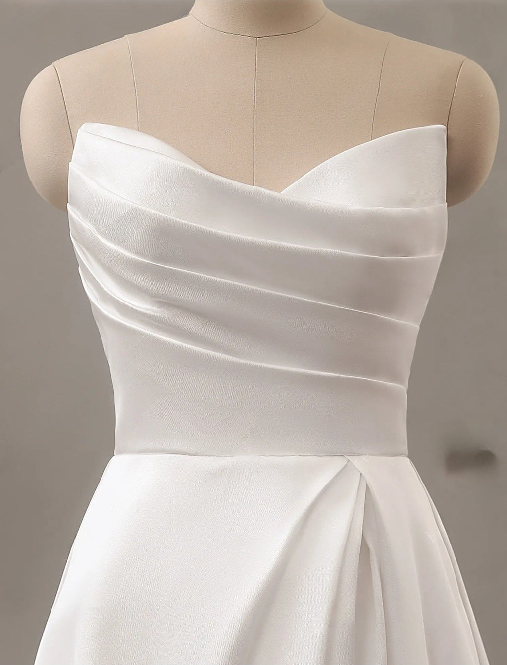 White strapless dress on a mannequin against a neutral background