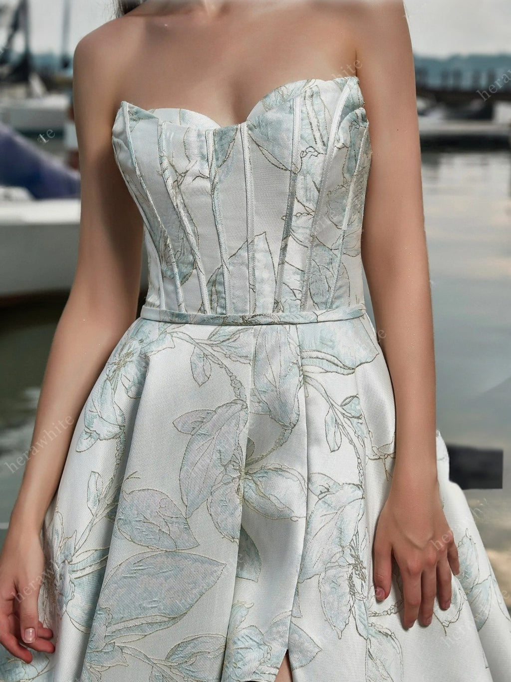 Woman wearing a strapless floral dress with a blurred background