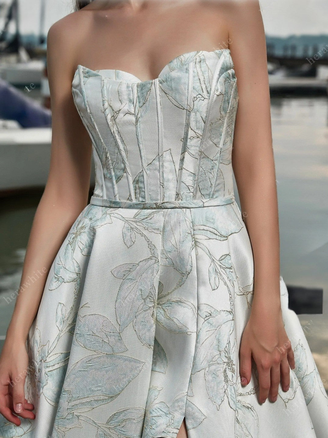 Woman wearing a strapless floral dress with a blurred background