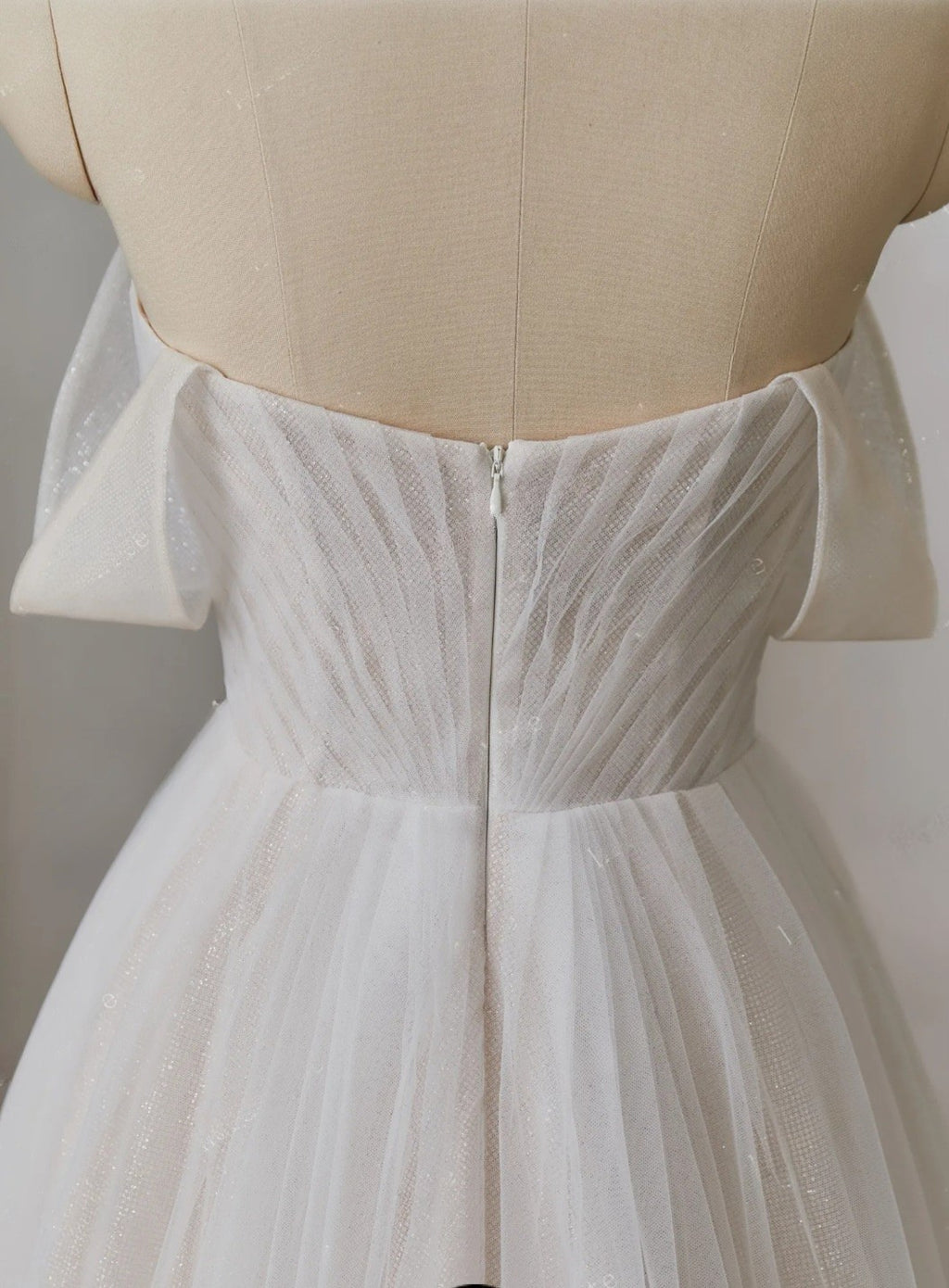 White dress on a mannequin with a neutral background