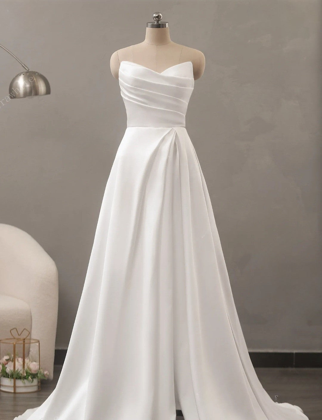 White strapless gown on a mannequin against a neutral background