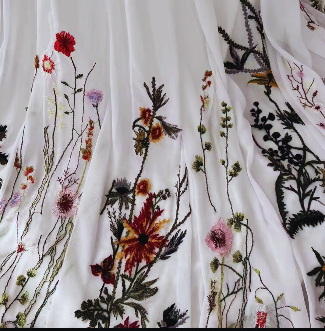 Embroidered fabric with floral patterns on a white background