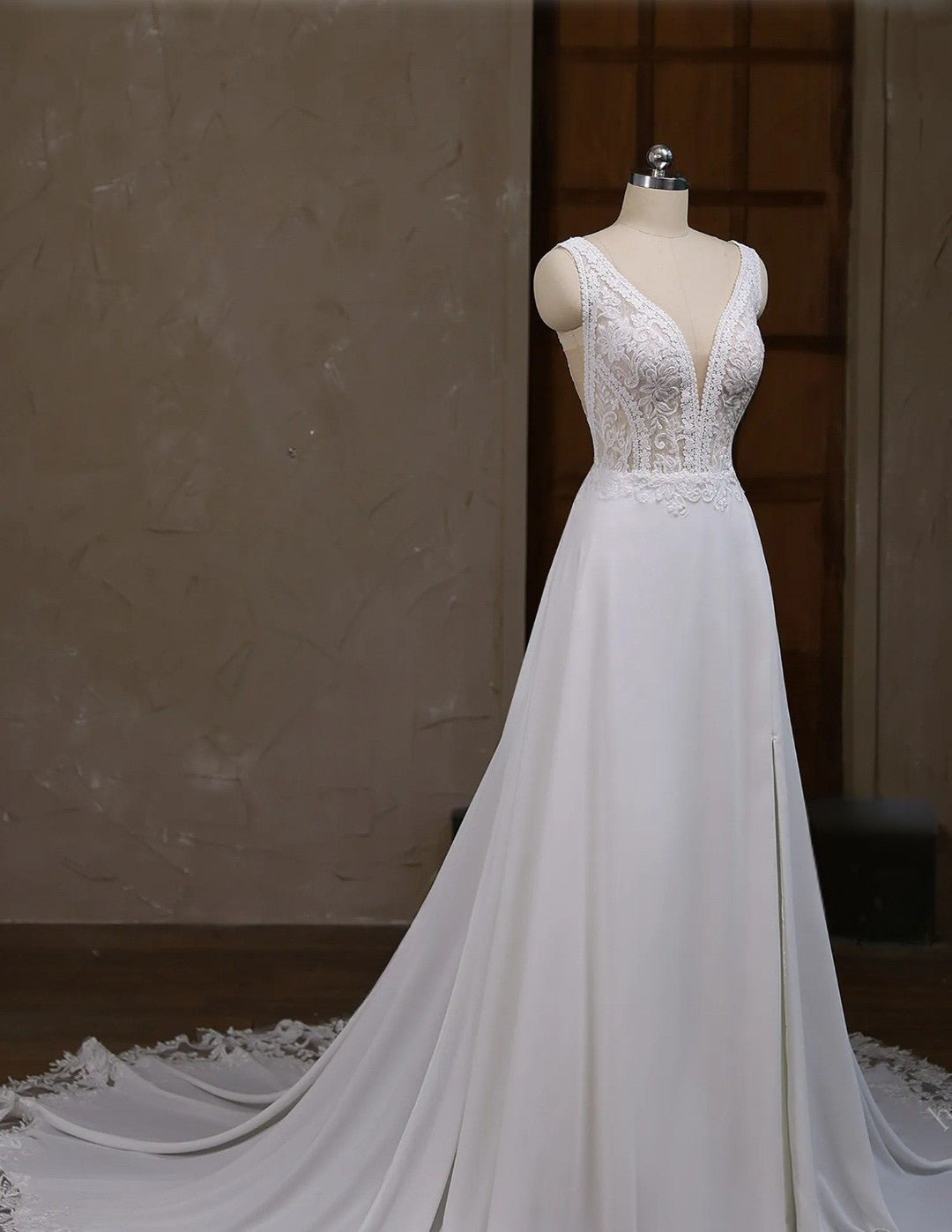 White wedding dress on a mannequin against a neutral background