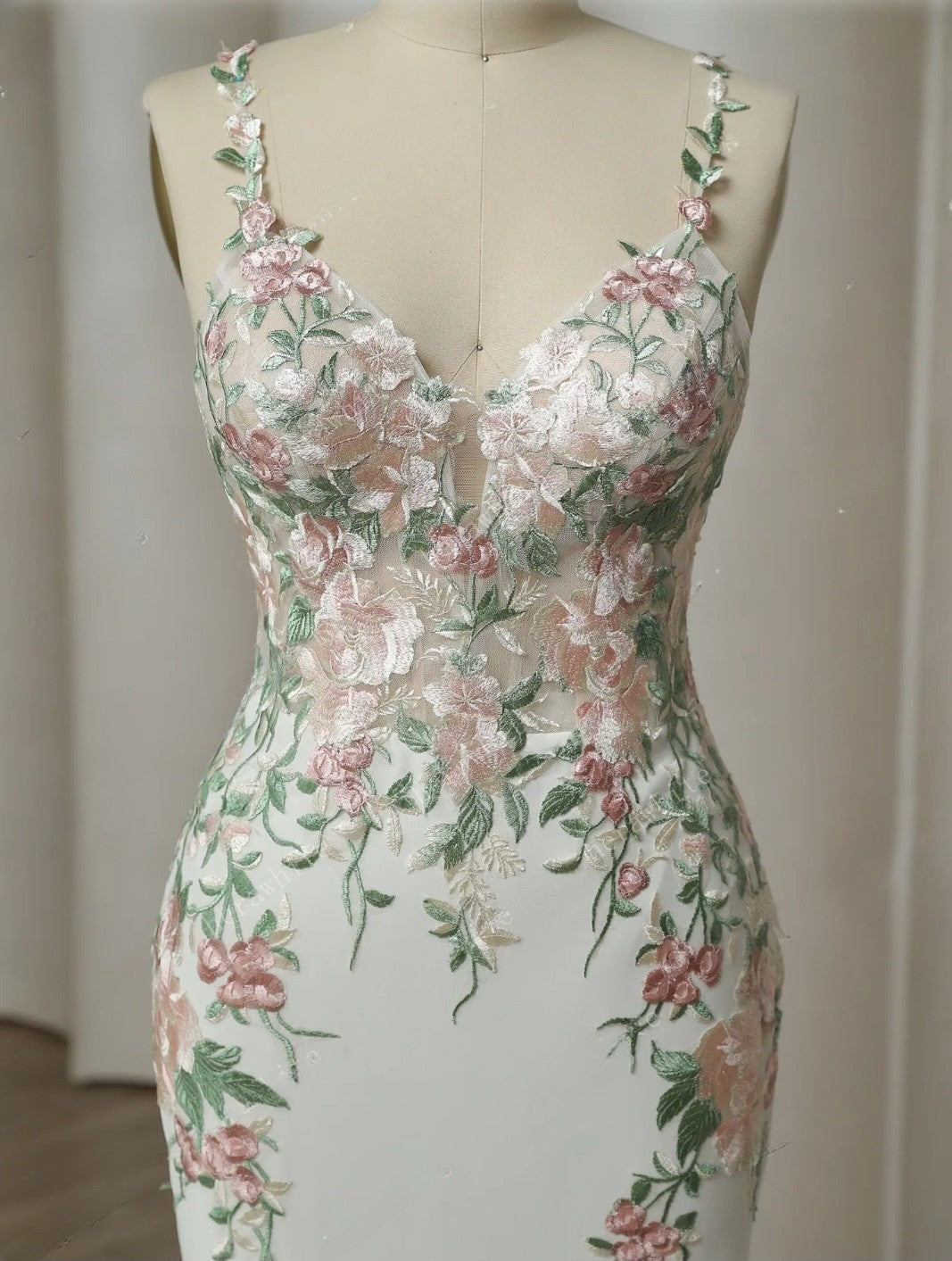 Floral dress on a mannequin against a plain background