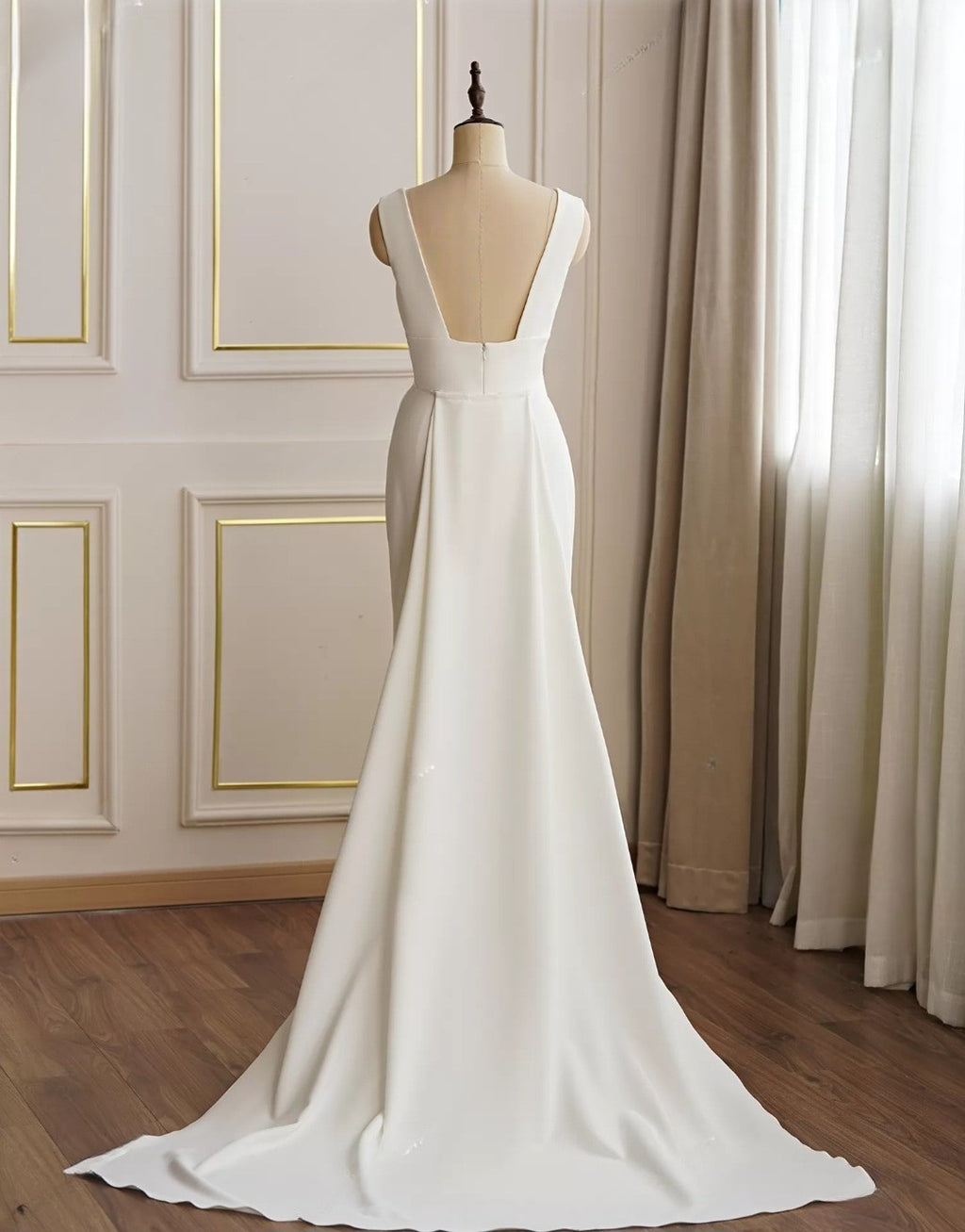 White evening gown on a mannequin against a neutral background
