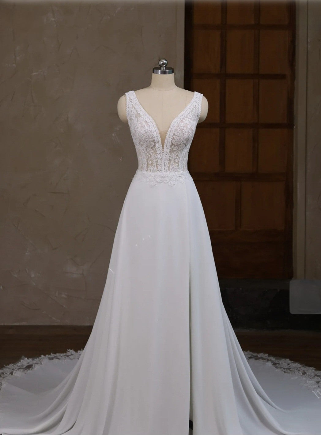 White wedding dress on a mannequin against a neutral background
