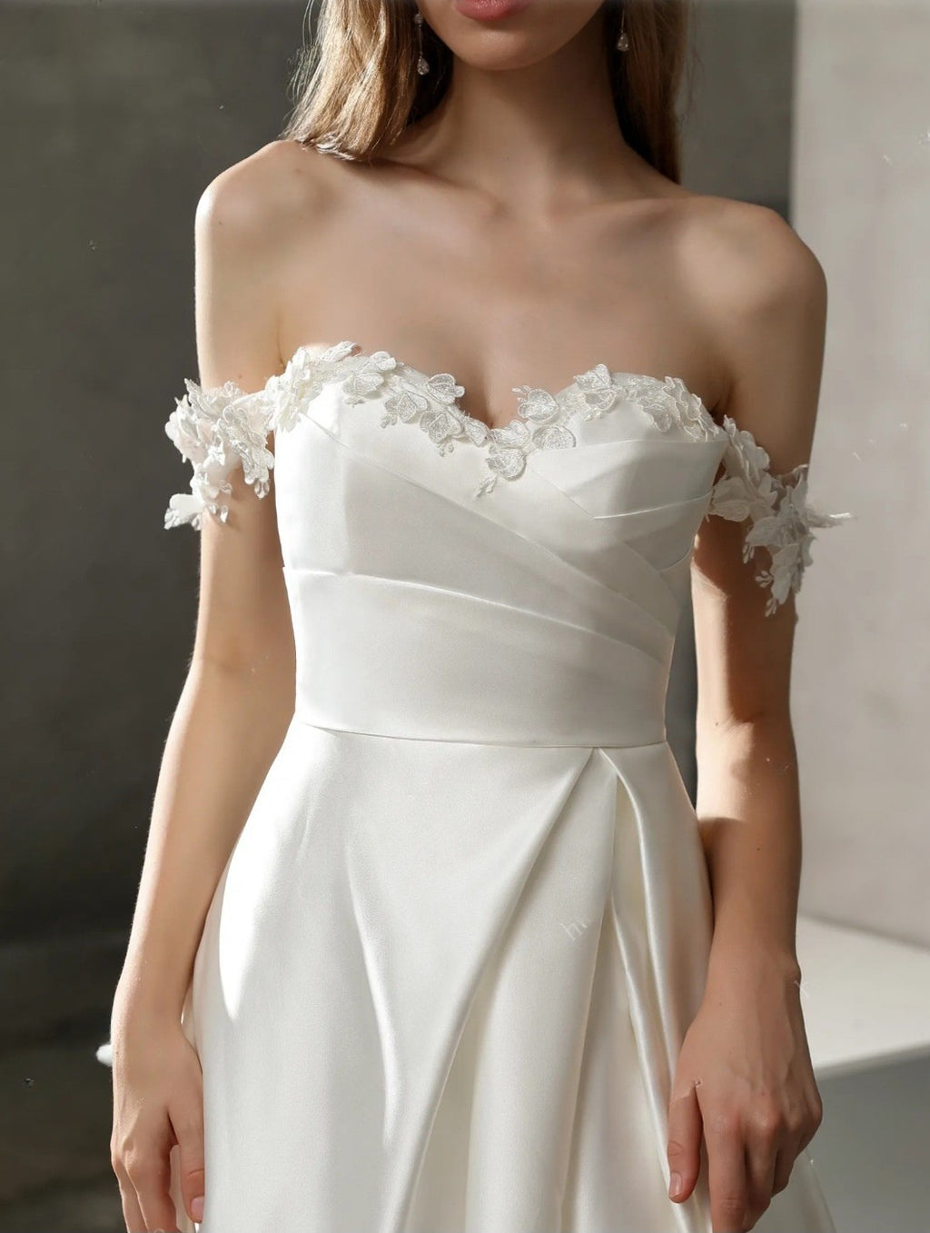 White strapless dress with floral details on a neutral background