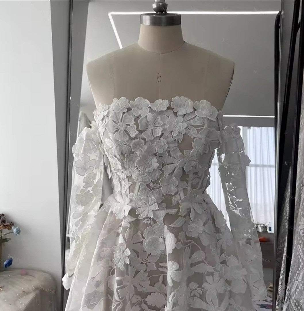 White floral lace dress on a mannequin against a neutral background