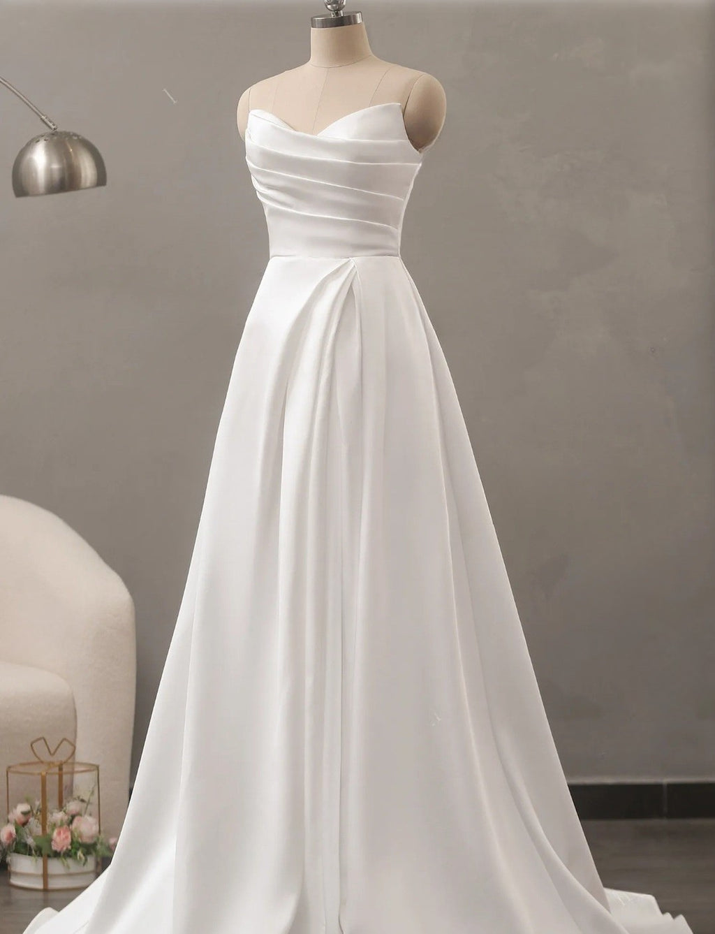 White strapless gown on a mannequin against a neutral background