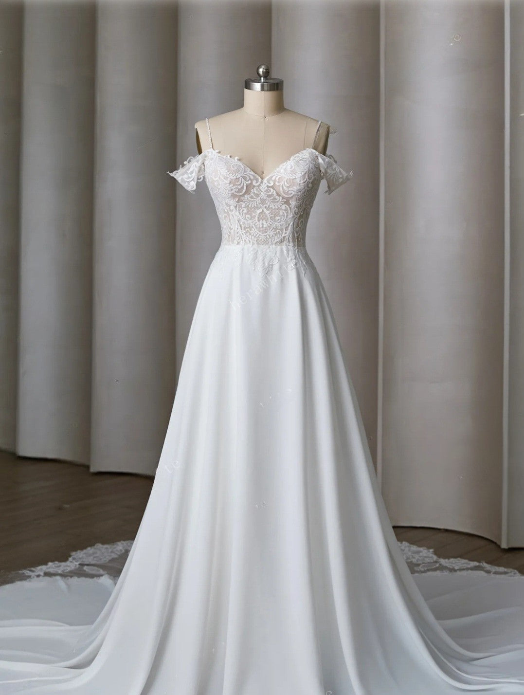White wedding dress on a mannequin against a neutral background