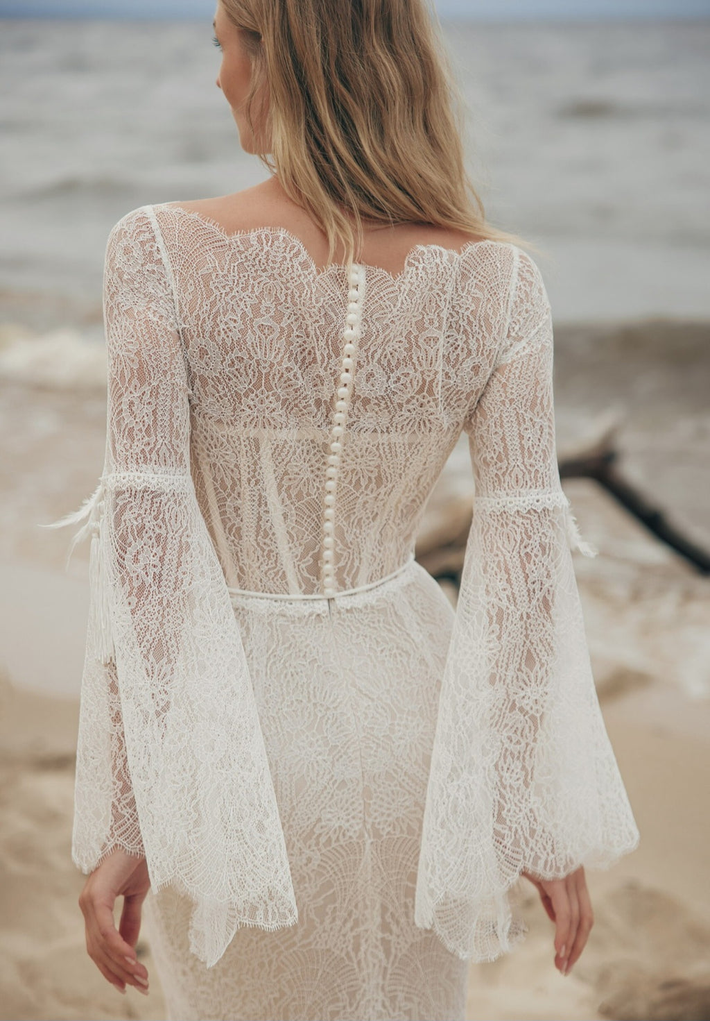 Woman wearing a lace dress on a beach