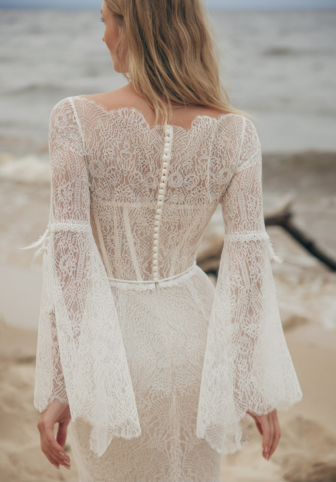 Woman wearing a lace dress on a beach