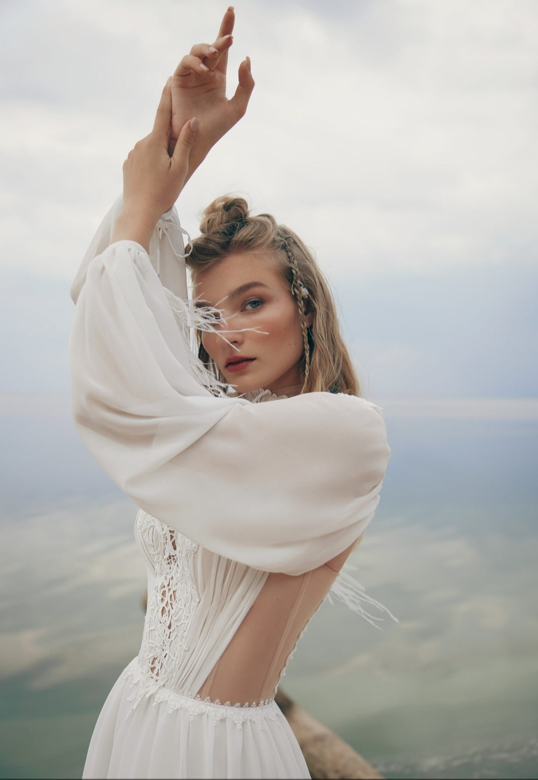 Woman in a white dress with a blurred natural background