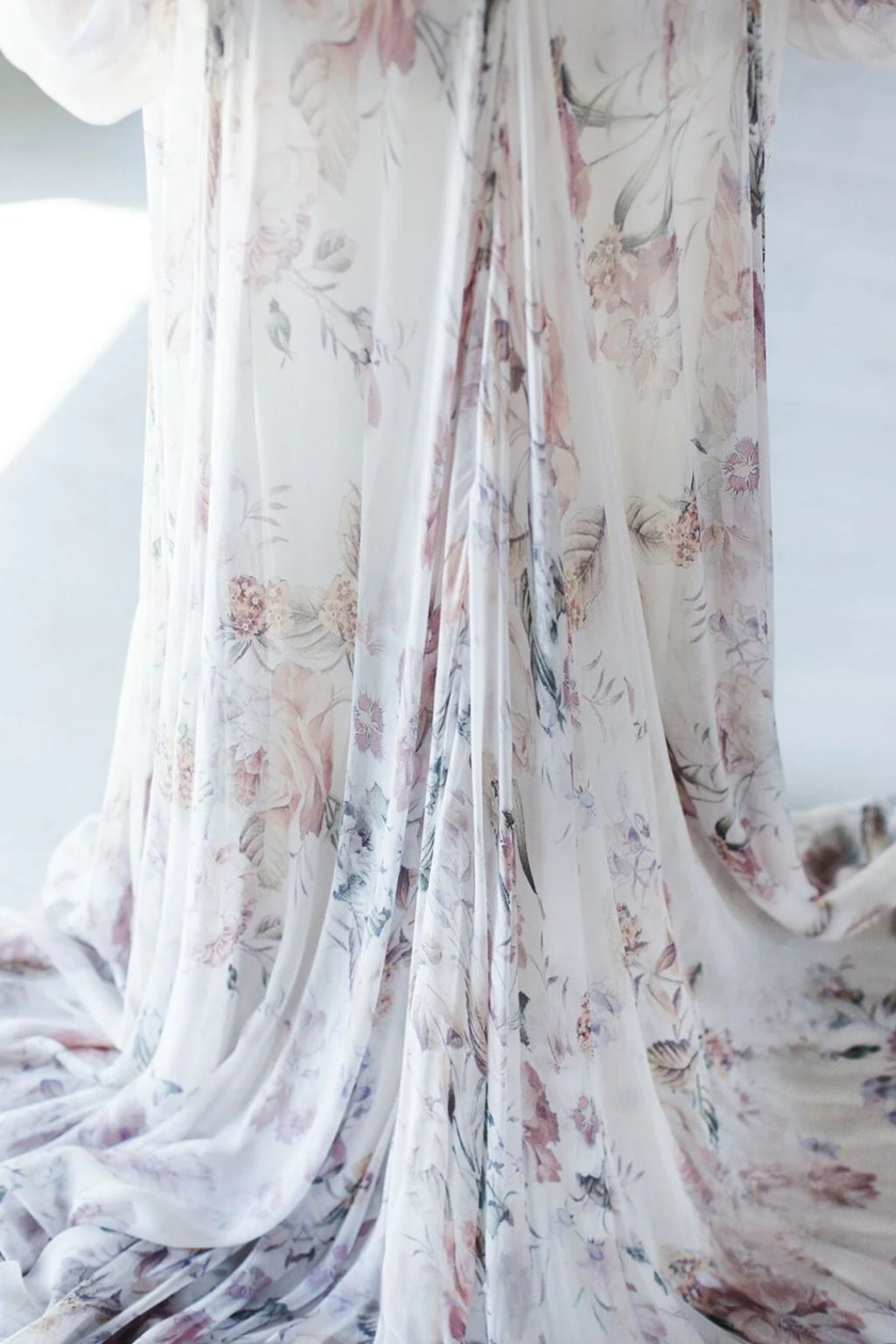 Floral patterned fabric draped over a white background