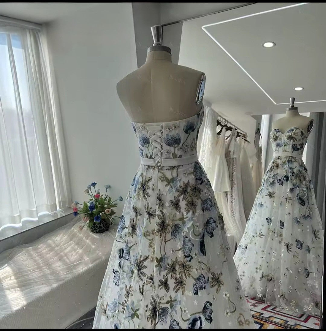 Floral dress on a mannequin in a bright room with large windows.