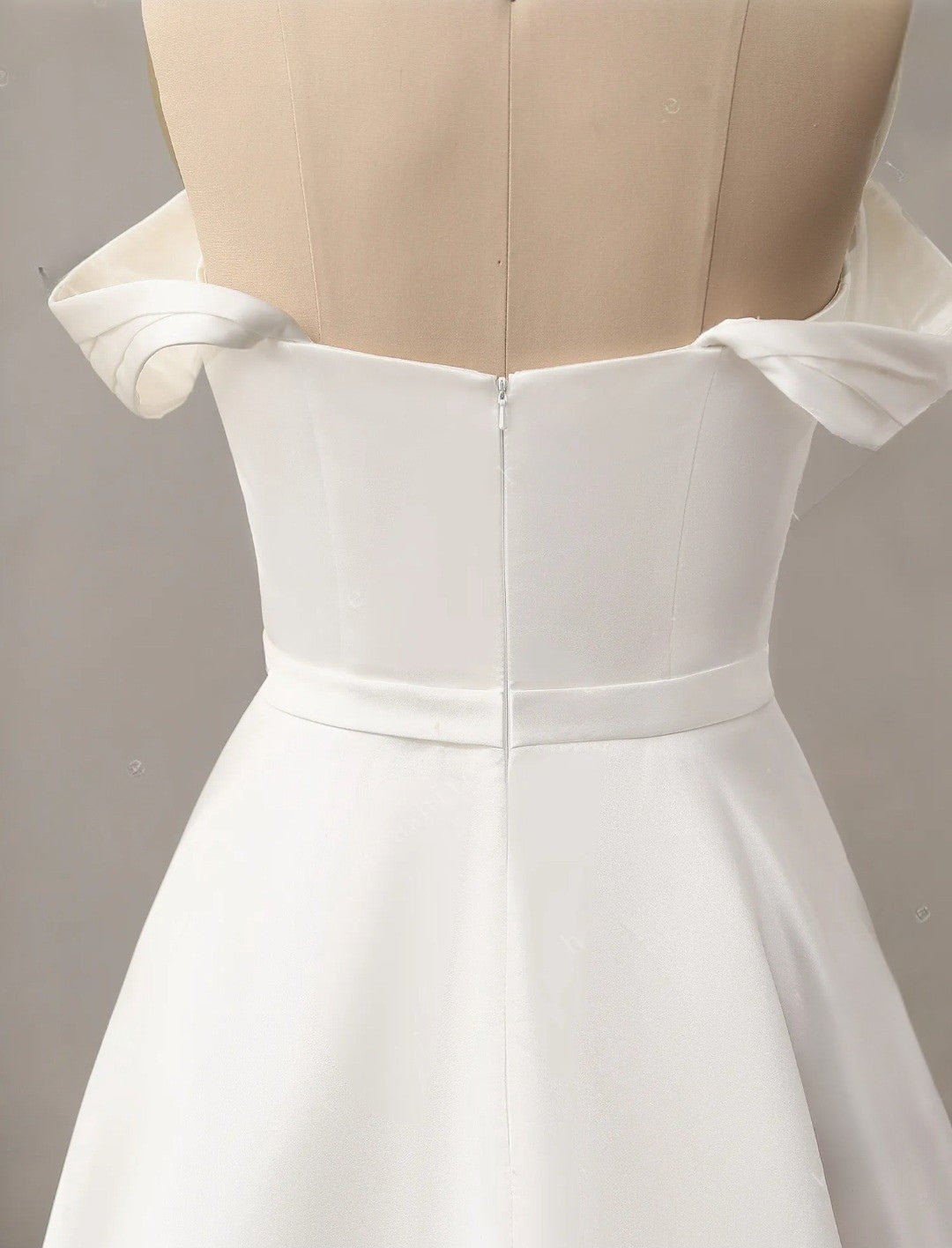 White dress on a mannequin with a plain background