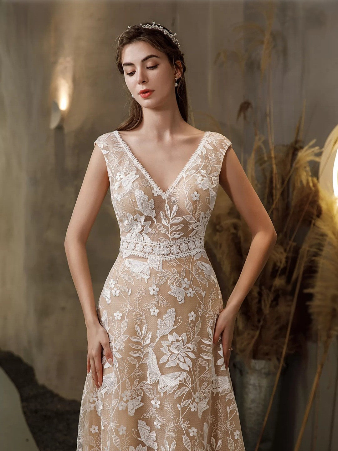 Woman wearing a floral lace dress with a neutral background