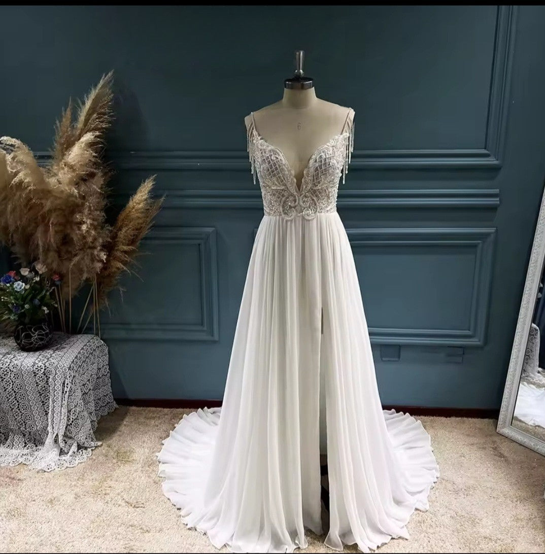 White evening gown on a mannequin against a dark blue wall.