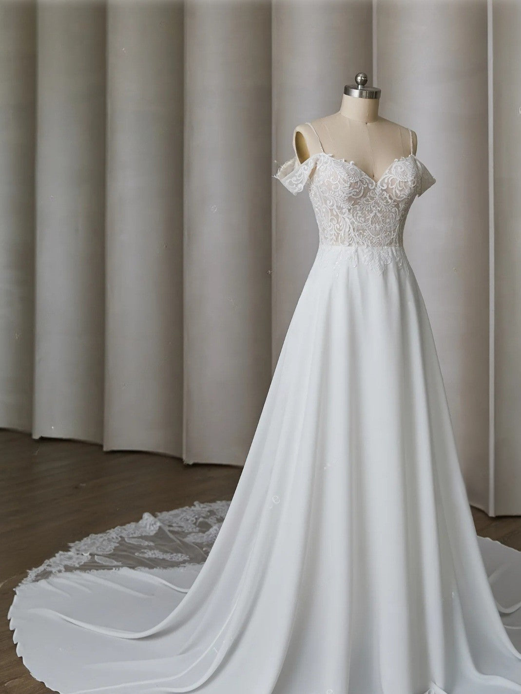 White wedding dress on a mannequin against a neutral background