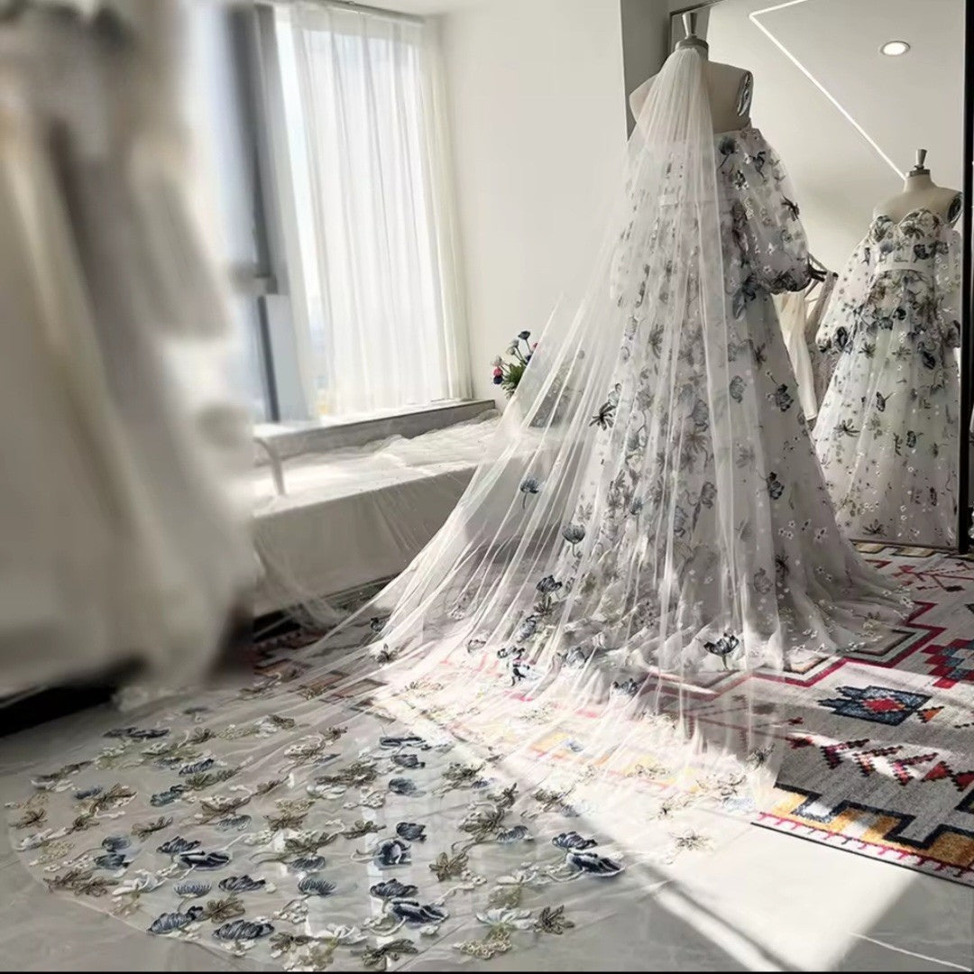 Floral dress on a mannequin in a bright room with large windows.