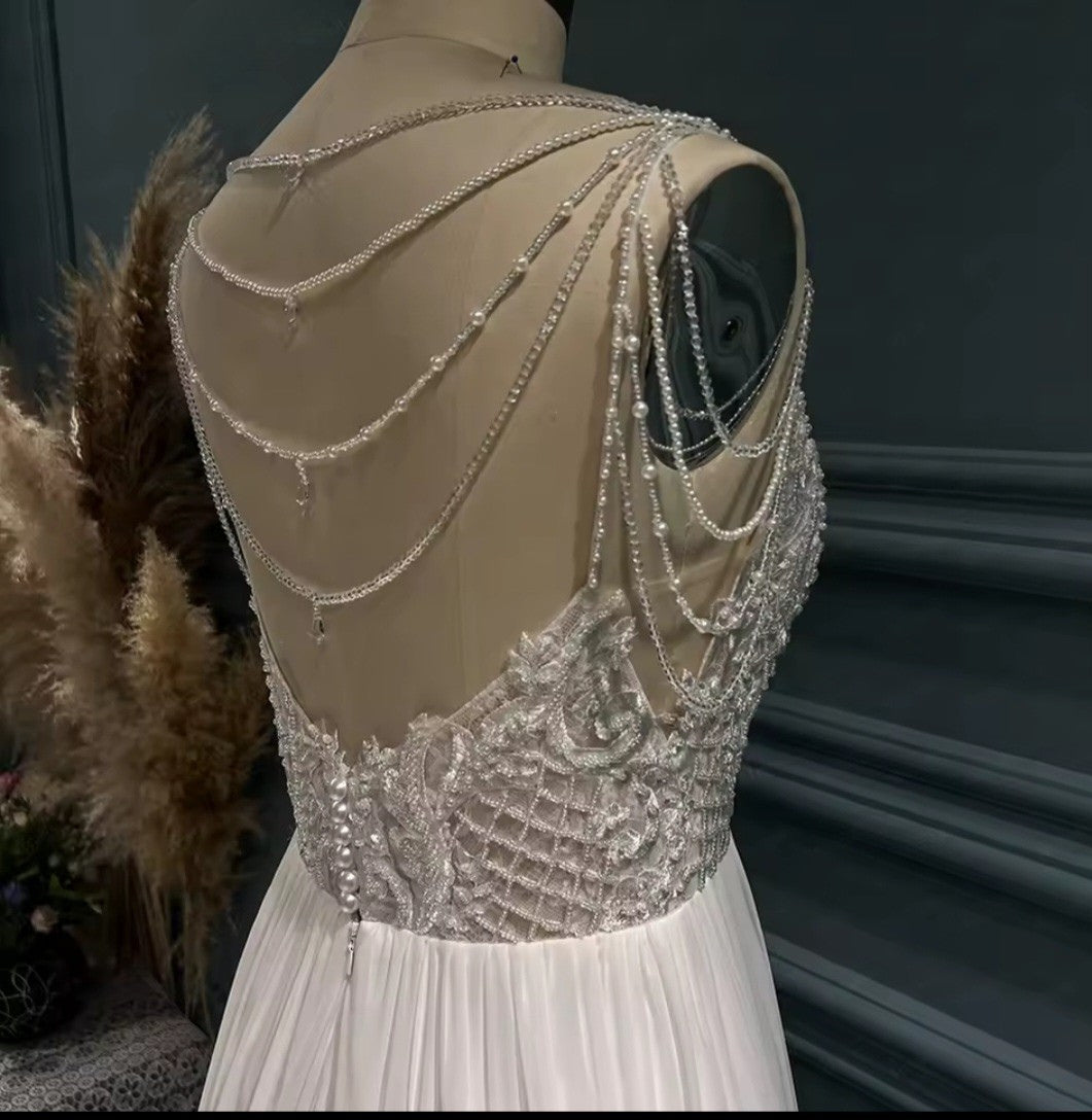 Beaded and embroidered dress on a mannequin with a dark background