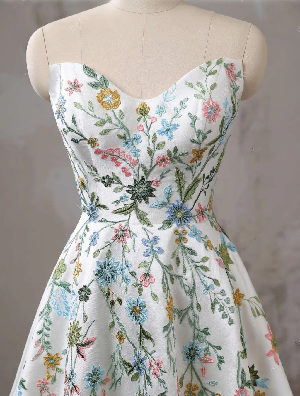 Floral dress on a mannequin against a neutral background