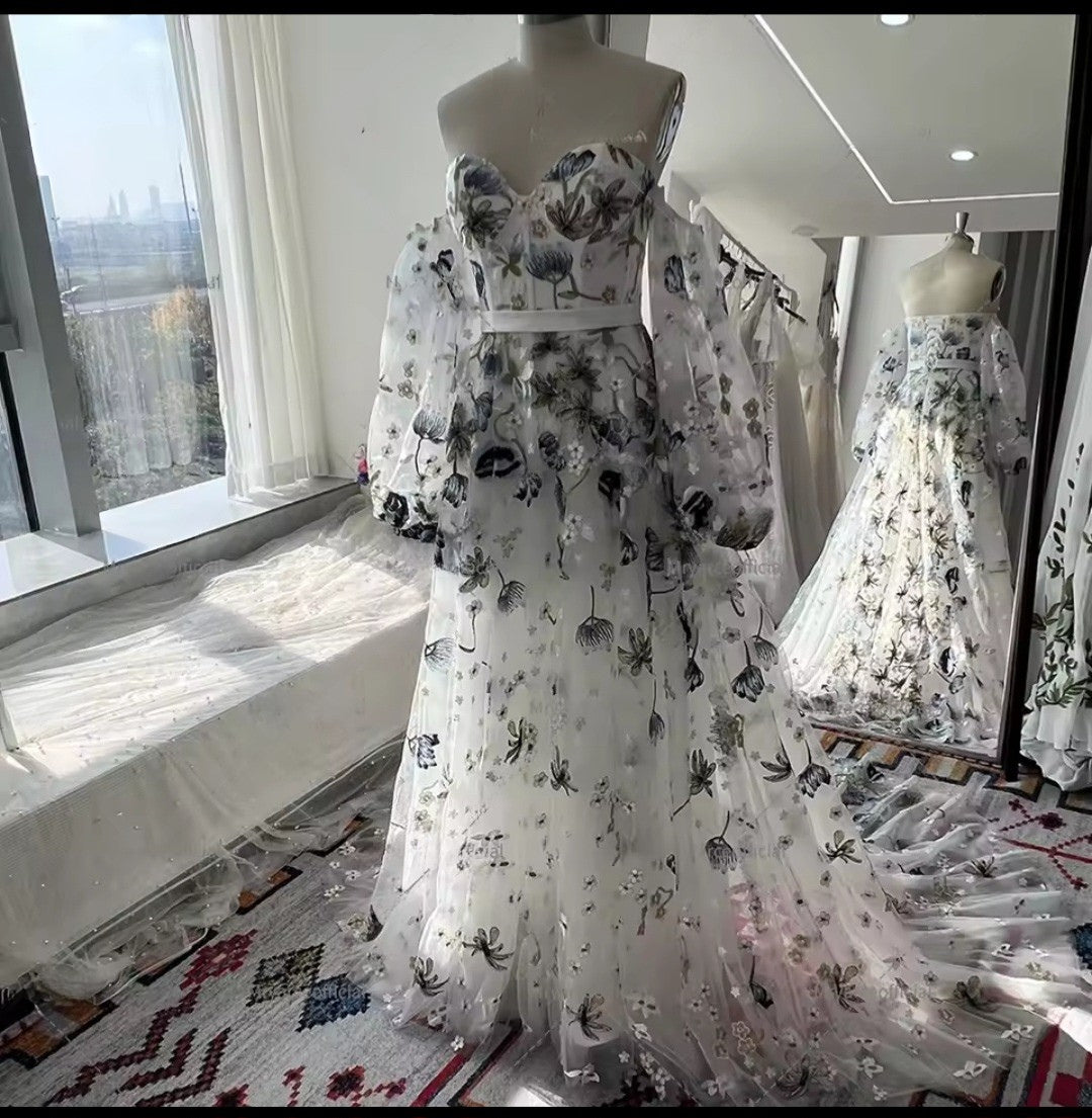 Floral-patterned dress on a mannequin in a room with large windows.
