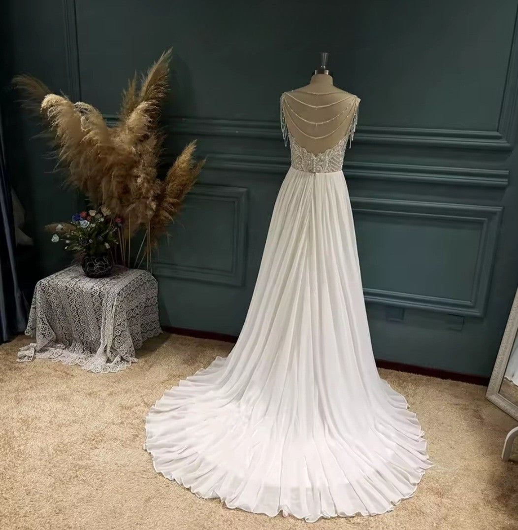 White wedding dress on a mannequin against a dark green wall.